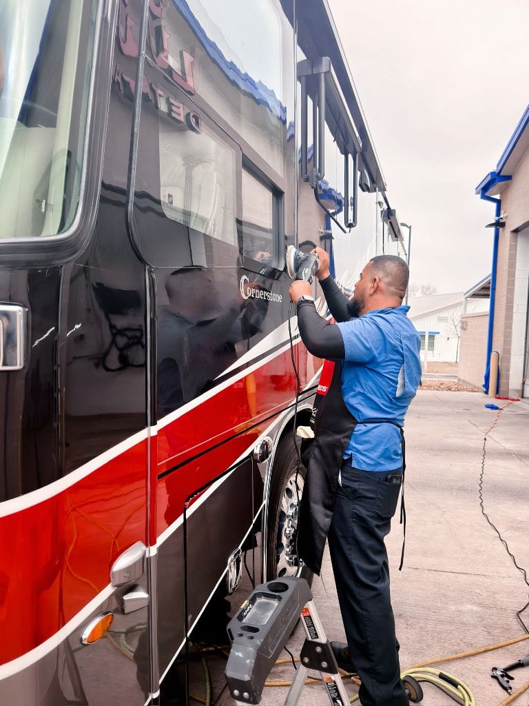 Brightworks Fort Worth detailer machine-polishing the side of a large Cornerstone motorcoach
