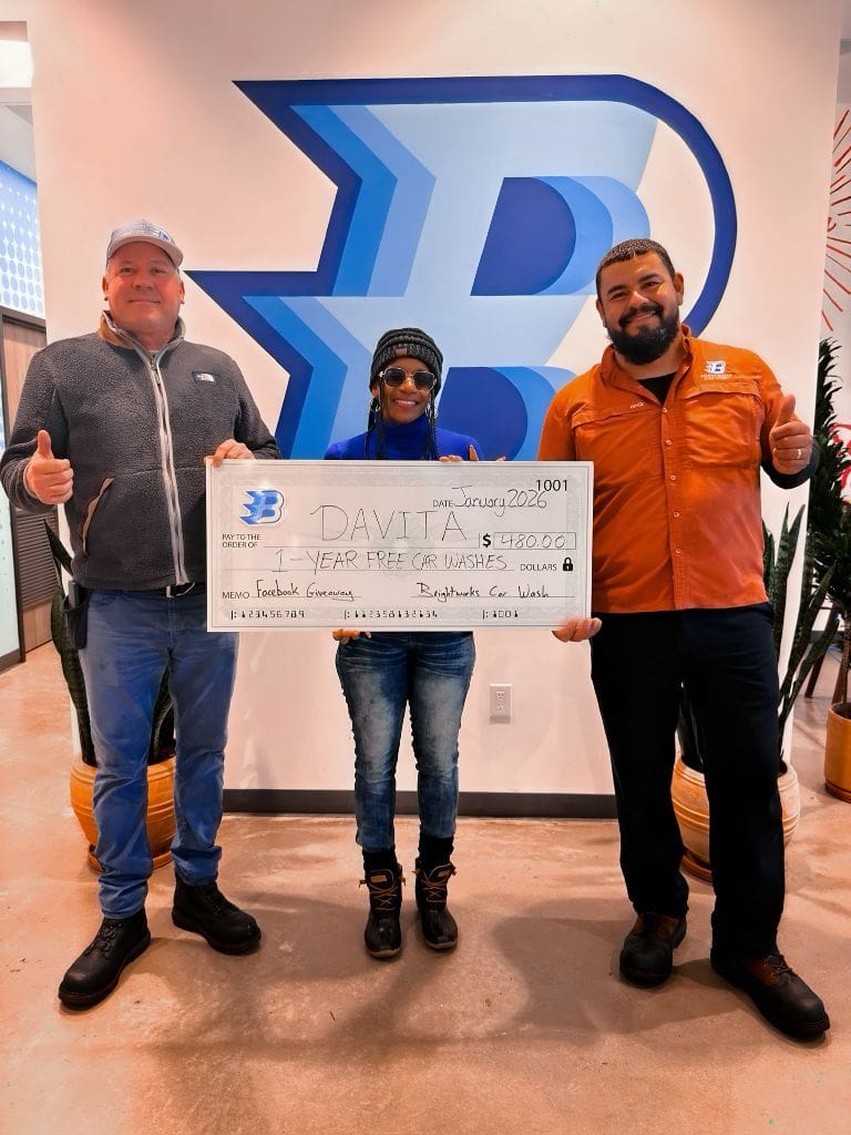 Brightworks Fort Worth Facebook giveaway winner Davita receiving a 1-year free car wash check