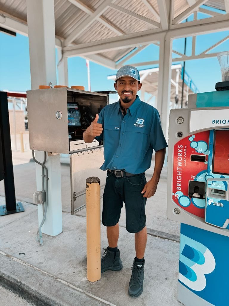 Brightworks Fort Worth team member giving a thumbs up at the car wash kiosk