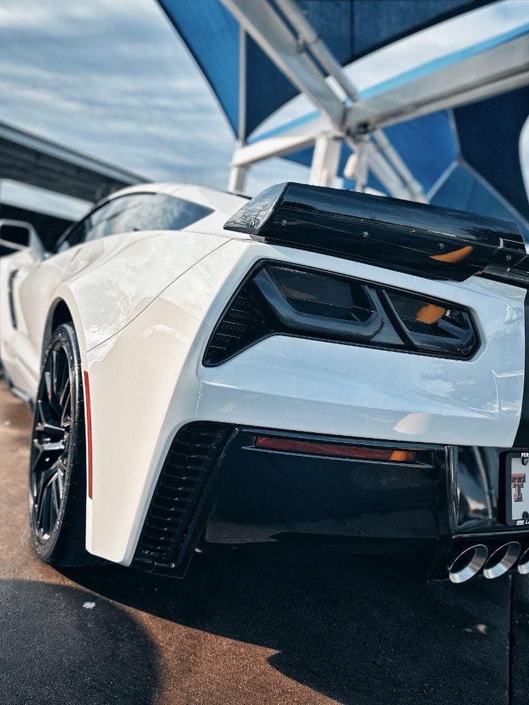 White Corvette Z06 rear quarter panel gleaming under the Brightworks Granbury pergola after a full detail